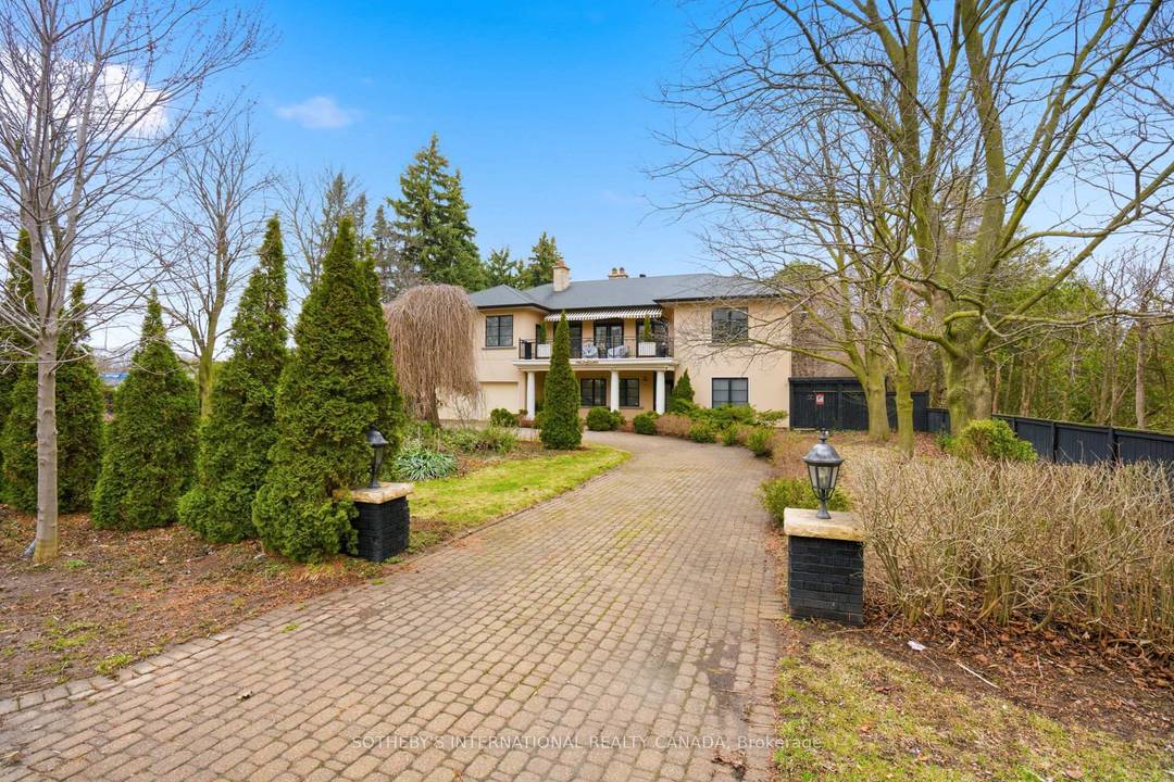 Welcome to 55 Pine Ridge Drive, a custom residence set on a private, tree lined ravine lot near the Bluffs.