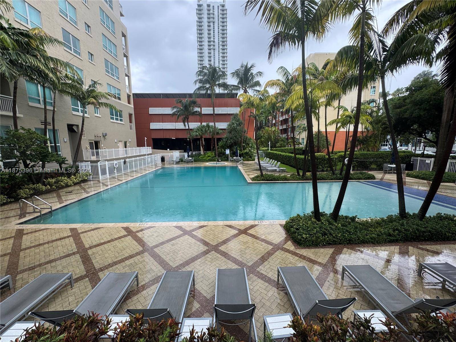 Spacious loft style 1BD 1BA at Cite on the Bay featuring soaring 14 ceilings, open layout, and private balcony with partial bay views.
