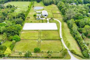 Beautiful 10 acre property with center aisle poured concrete barn 8 supersized stalls, all with hurricane shutters and screens, 2 wash stalls, full bathroom, tack room, 2 utility feed rooms, ...
