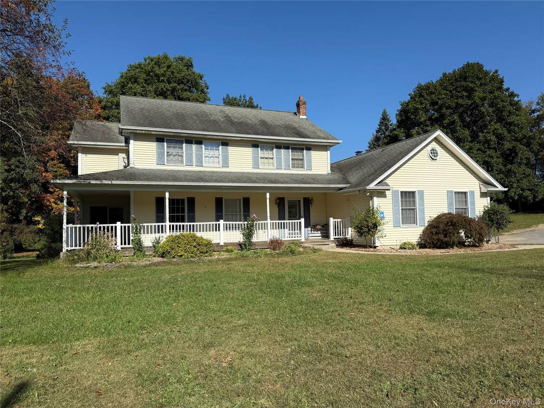 Nestled quietly at the end of a private drive, set back from the gentle hum of a town road, stands a gracious colonial home on a generous 2.