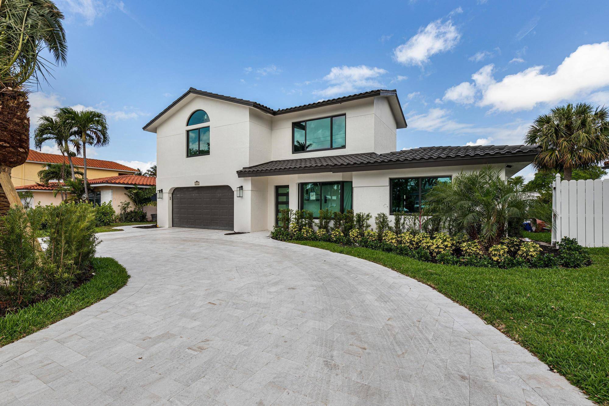 Nestled on a serene cul de sac in Pompano Isle, this fully renovated waterfront home is a masterpiece of modern luxury and coastal charm.