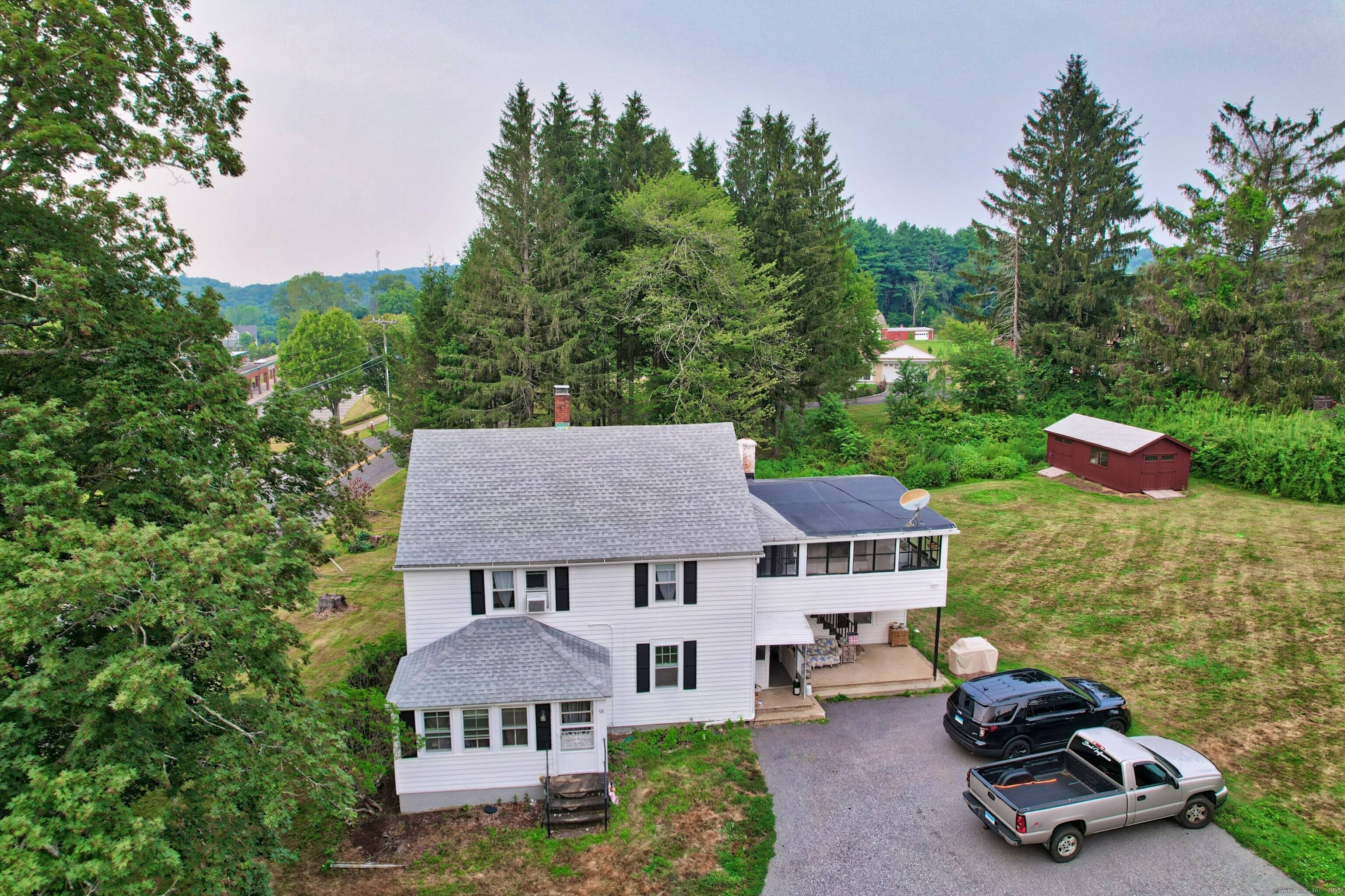Charming Two Family home situated on over three quarters of an acre !
