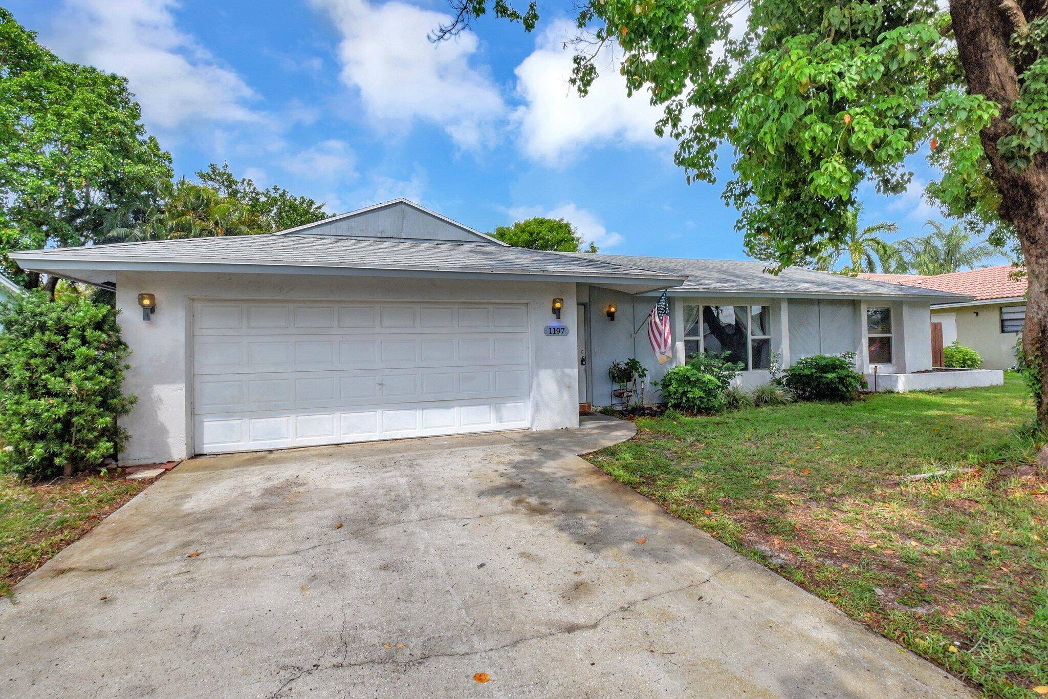 Charming home featuring a newer roof and air conditioners, granite countertops, and rich wood cabinets in the kitchen.