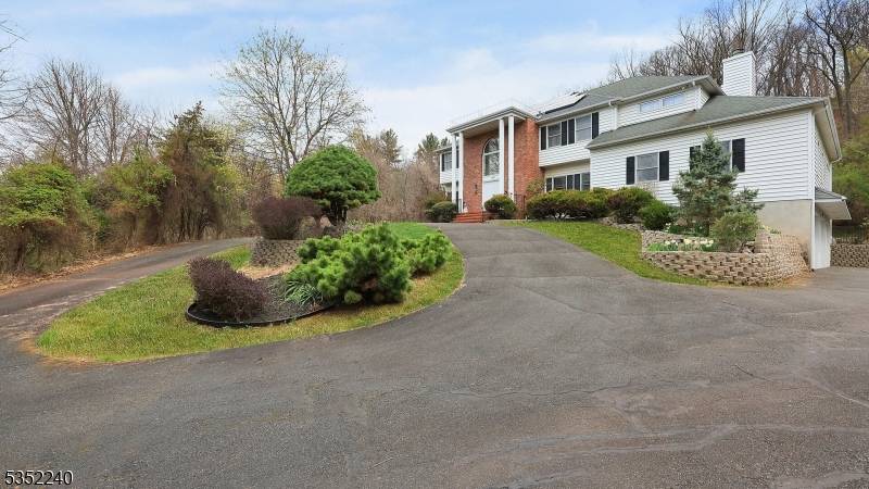 Perched on a hill and set far back from the road, this classic center hall colonial offers timeless elegance, privacy, and stunning views of the secluded preserved land it backs ...