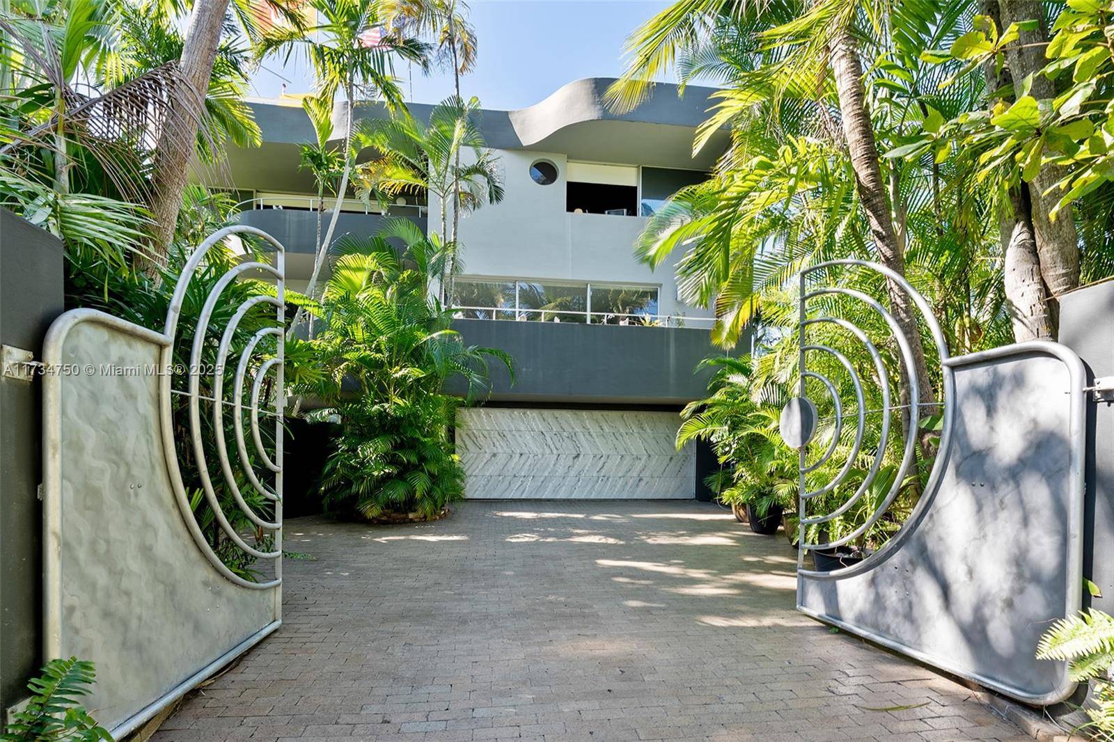 Sensational, walled amp ; gated architectural masterpiece set within a lush botanical garden of exotic palms and native tropical greenery.