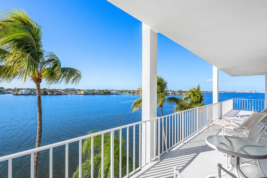 Unobstructed Intracoastal views to the west and north from a wraparound terrace define this spacious, fully renovated residence, finished with the finest materials in elegant neutral tones.
