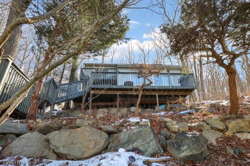 Welcome home to this 3 bedroom, 2 bathroom Contemporary home nestled on a serene wooded lot overlooking Skyline Lakes.