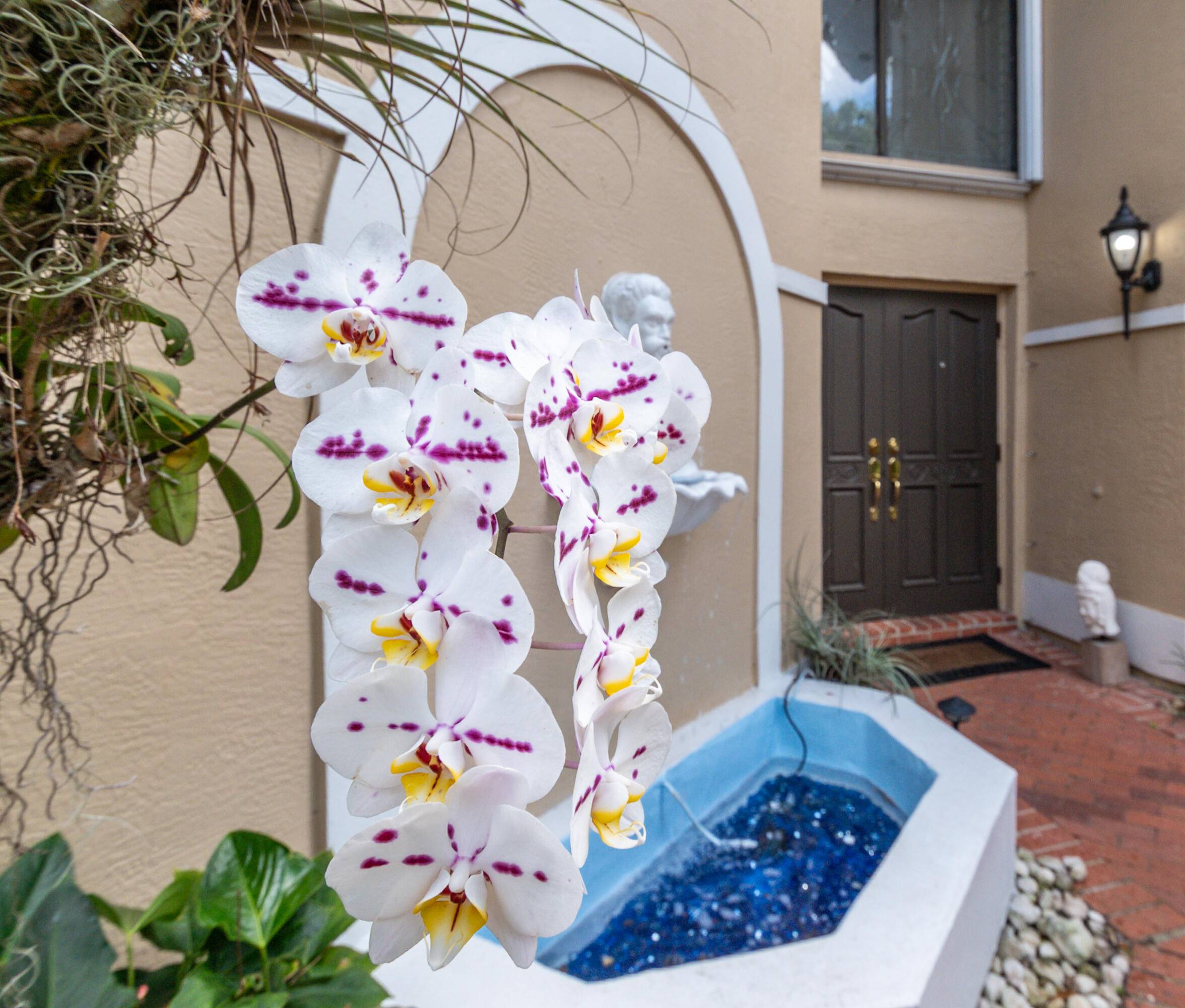 Tucked behind lush landscaping in a private gated setting, this elegant residence offers spacious living with timeless charm.