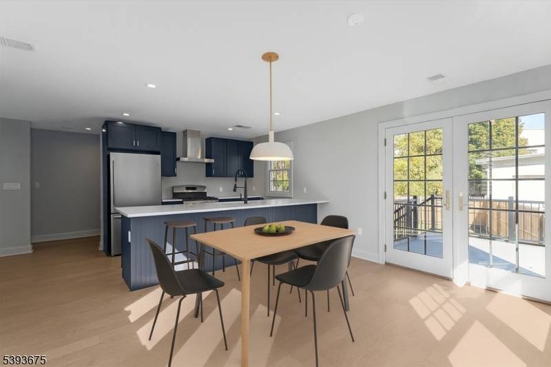 Newly renovated rental offering a modern kitchen with stainless steel appliances flowing seamlessly into a bright family room.