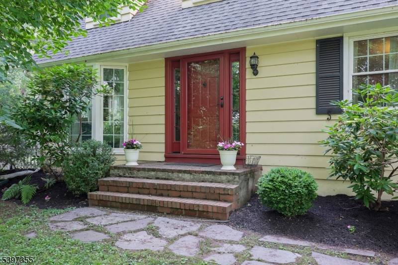 This extraordinary custom built cape cod, set back on 1.