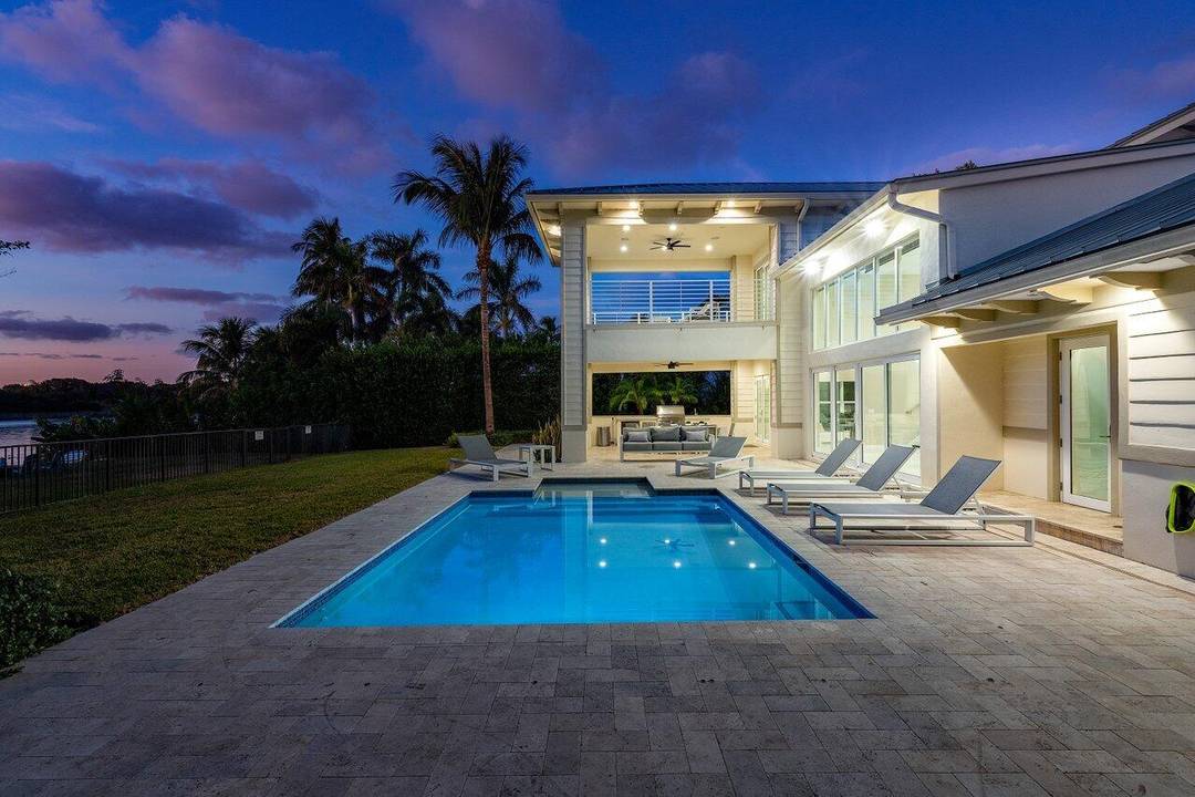 Indulge in the ultimate Delray Beach lifestyle with this 2017 coastal contemporary estate, ideally situated on a quiet street and set on a premier lakeside lot.