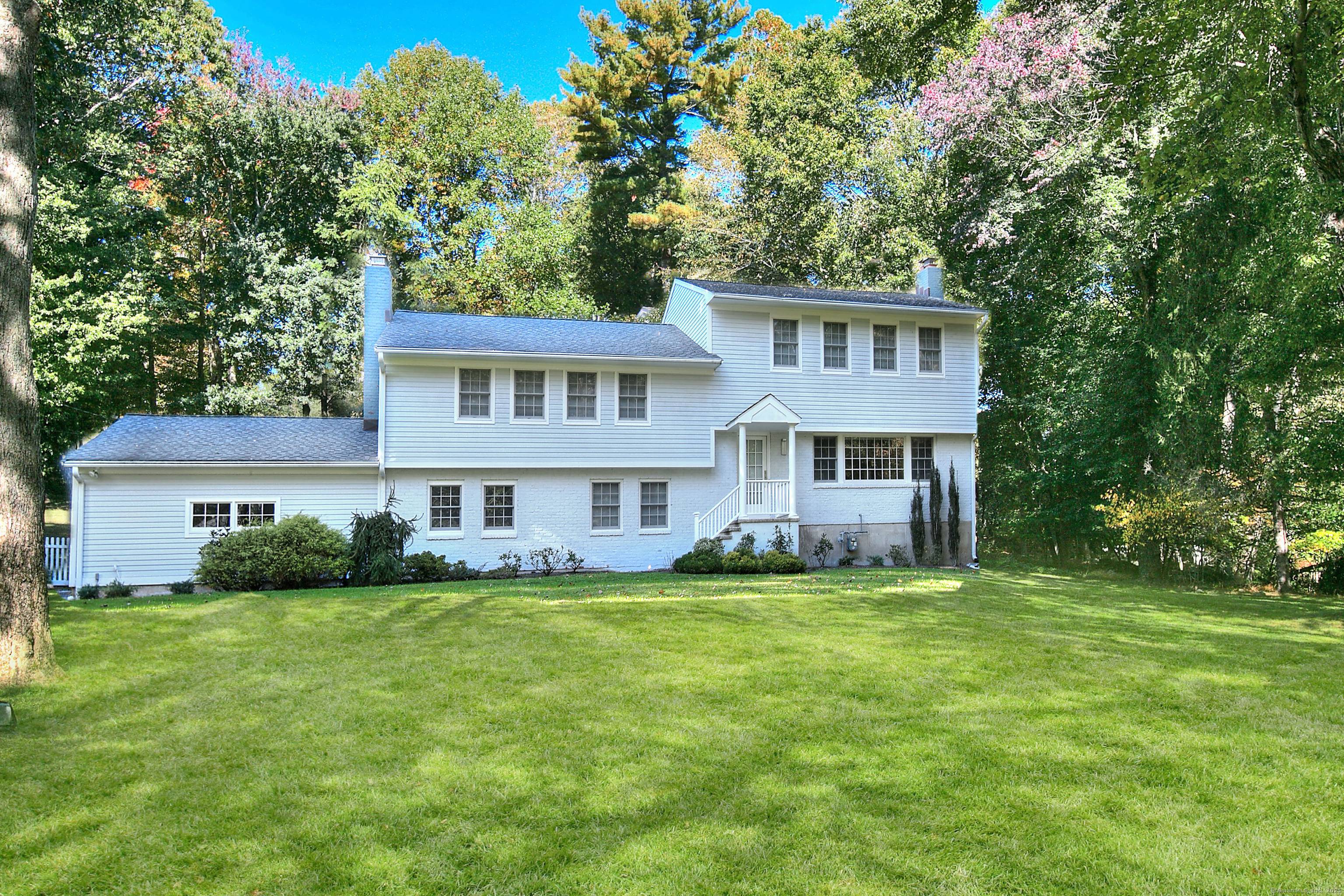 Located on a quiet neighborhood street, this 5 bedroom home spans a full acre, offering a tranquil setting for your summer retreat.