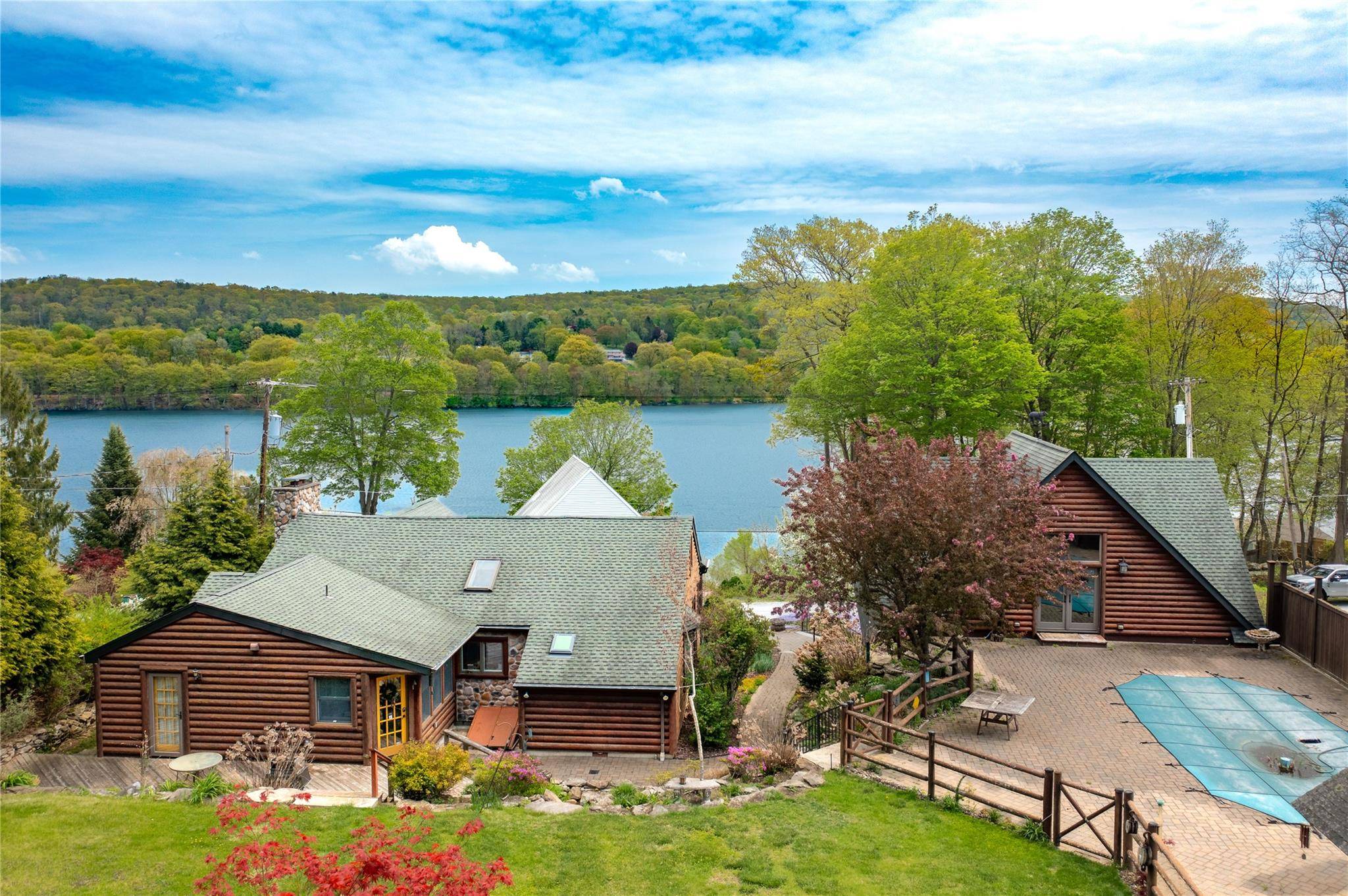 Welcome to 81 Lakeview Drive a quintessential log cabin estate offering deeded lake rights and endless opportunities to embrace the coveted Whaley Lake lifestyle.