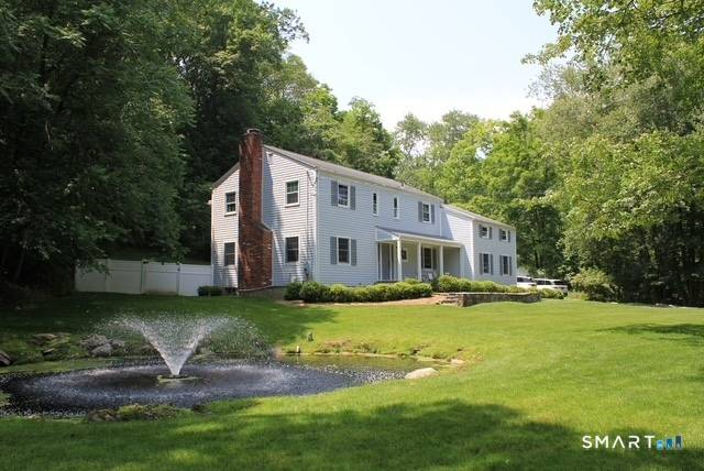 Nestled in the coveted Old Hill section of Westport, this exceptional residence offers a rare blend of space, serenity, timeless appeal.