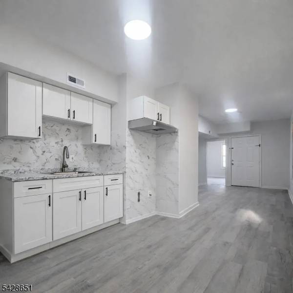 Exceptional investment opportunity, this well maintained 3 family property offers a total of 9 bedrooms, providing generous living space and strong income potential.