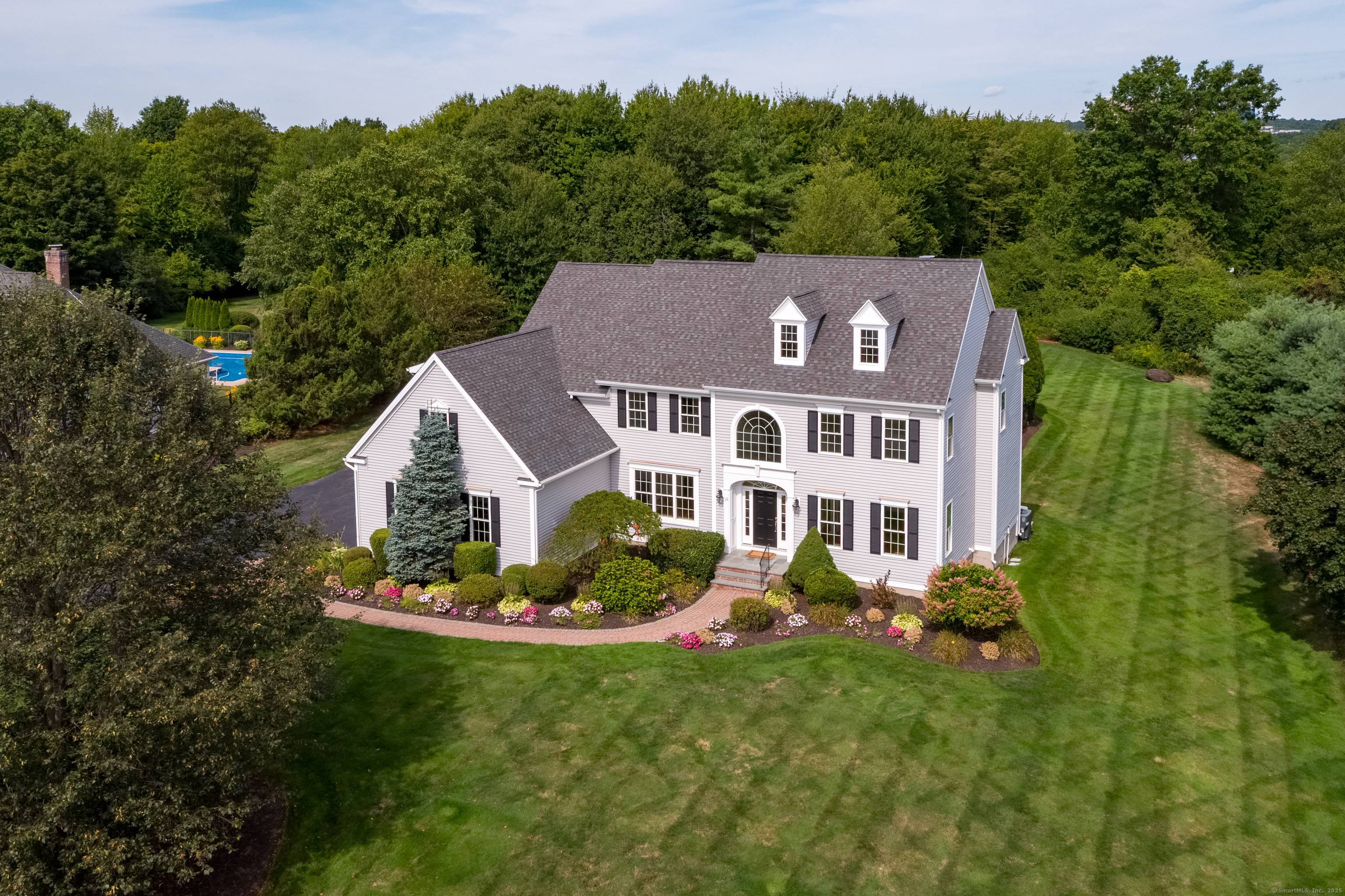 Exquisite gardens, lush greenery sweeping manicured lawns beautifully frame this custom built Colonial on a prime park like level homesite in sought after rarely available east side neighborhood of fine ...