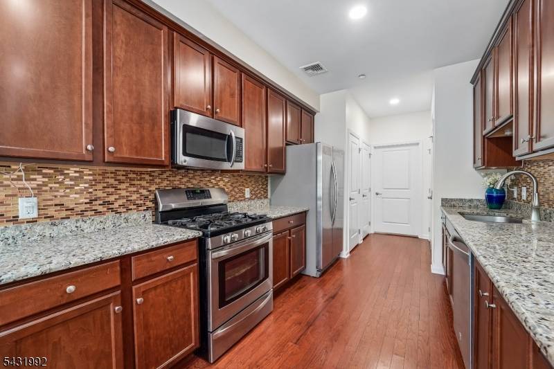 Welcome to a refined townhome in one of Morris Plains' most coveted communities, Coventry Park.