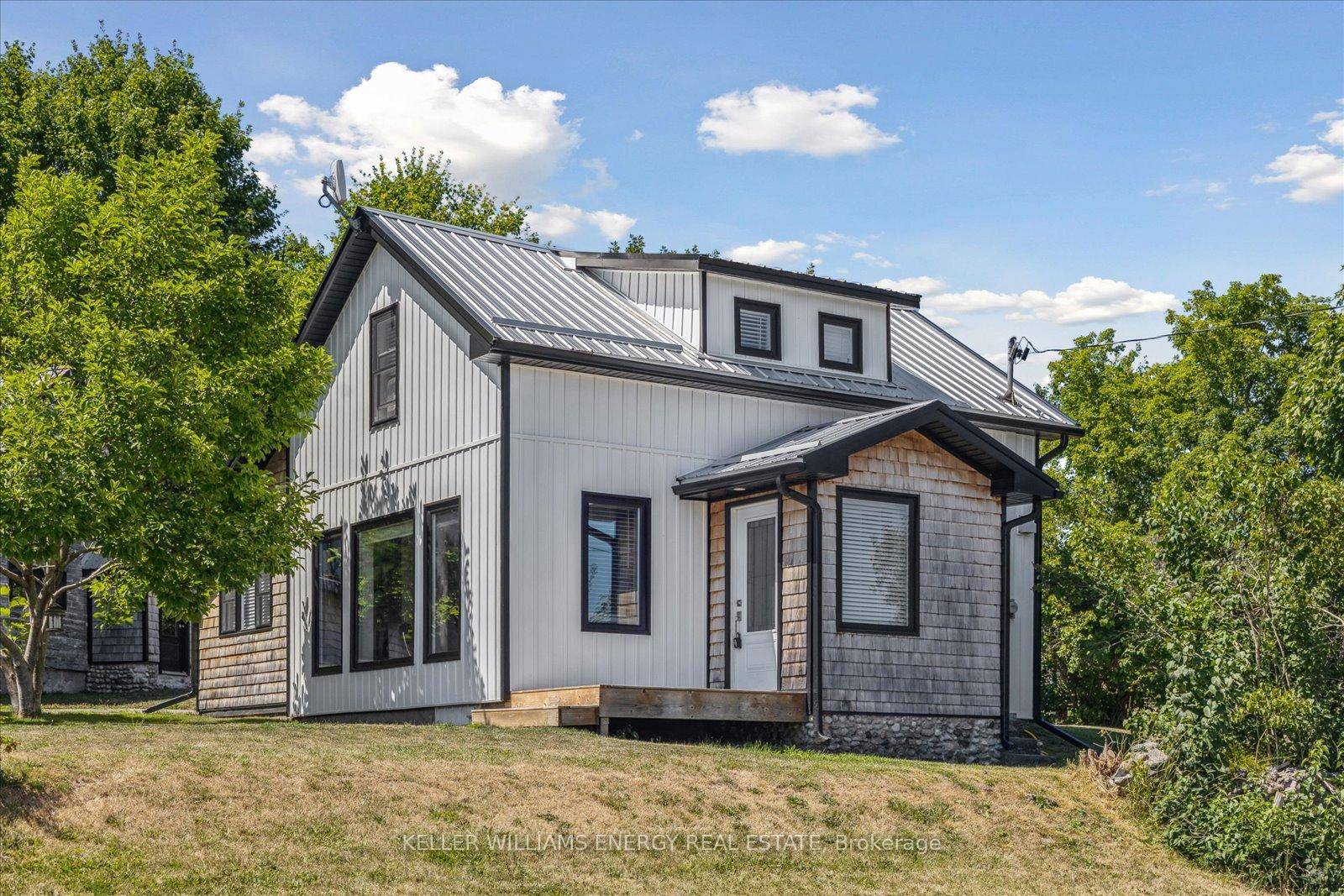 Modern Farmhouse Warmth Meets Mid Century Style in This Turnkey Retreat.