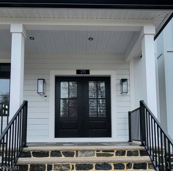 This stunning one of a kind renovation greets you with an oversized slate porch and glass double front door.