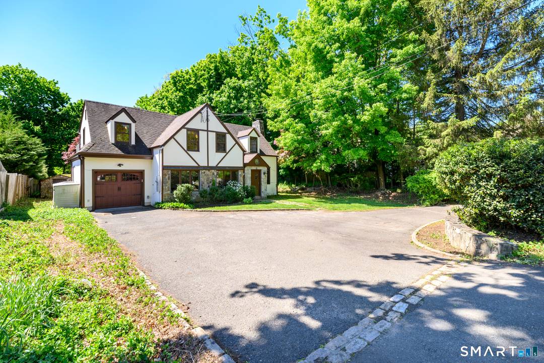 Rare Tudor gem in lovely quiet neighborhood of impressive homes in sought after convenient location.