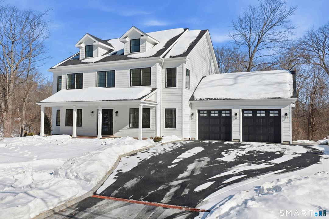 Brand new construction at 511 Den Road offers refined modern living in a peaceful North Stamford setting on 1.