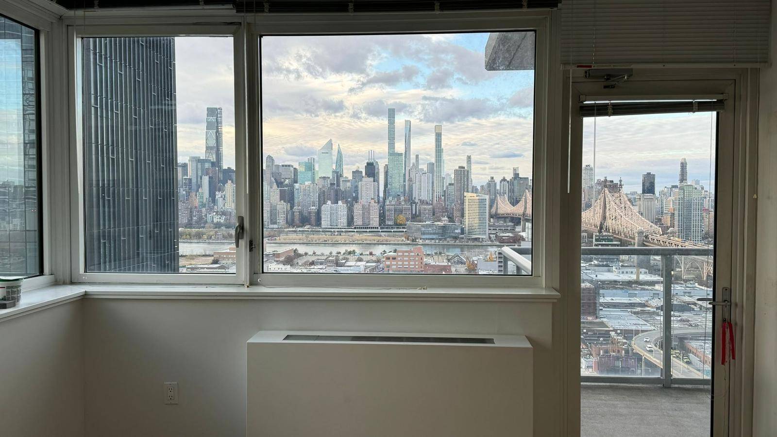 Sunny 2 bedroom apartment with beautiful Manhattan views, a large balcony, floor to ceiling windows, and a sprawling view of the skyline.