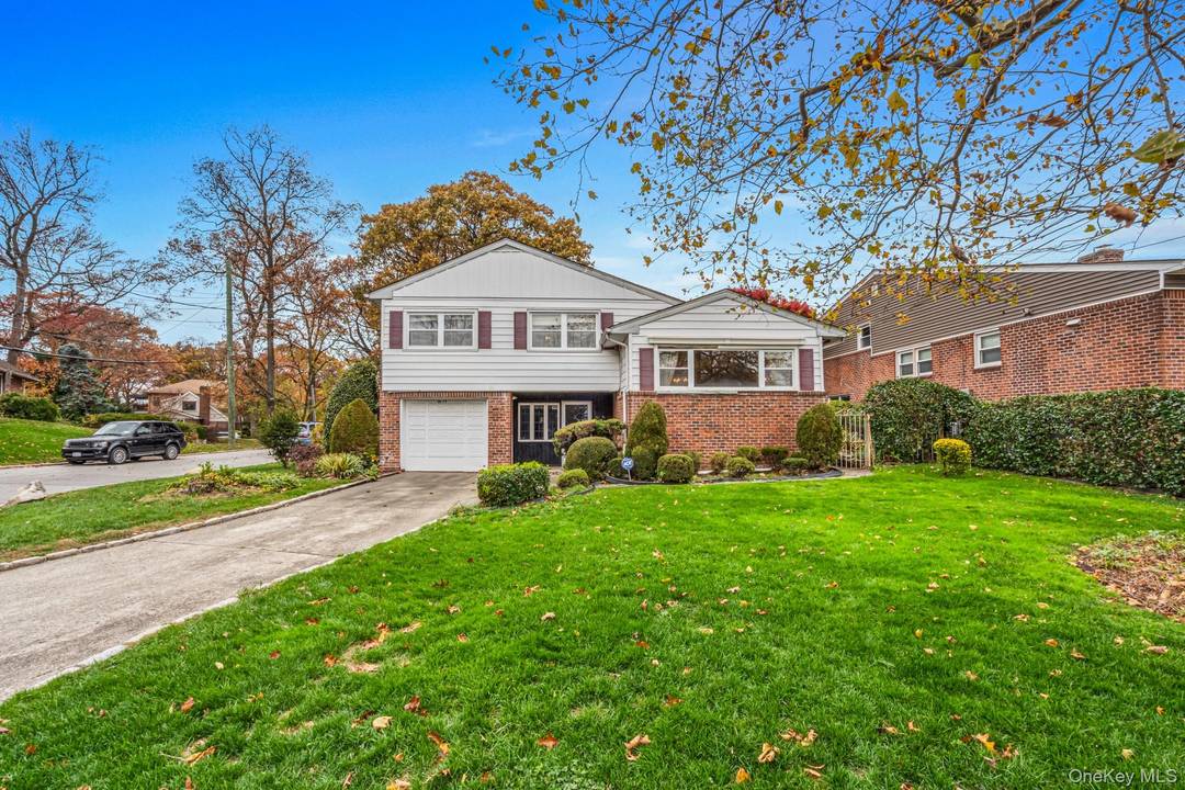 Fall in love with this welcoming Split Ranch set on a pristine corner lot in desirable Holliswood.