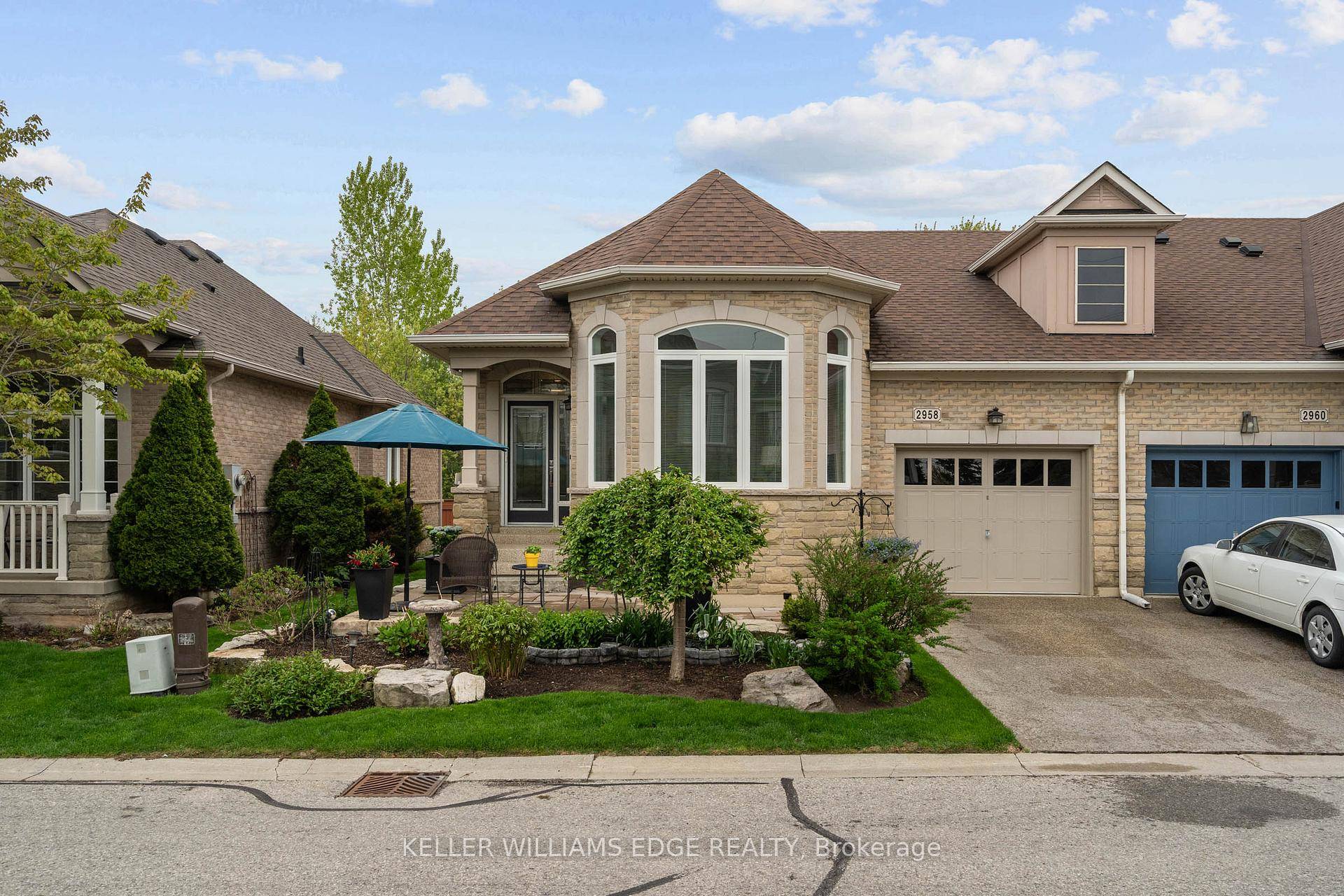 Exceptional end unit BUNGALOW townhouse backing onto protected green space in a sought after north Burlington location.