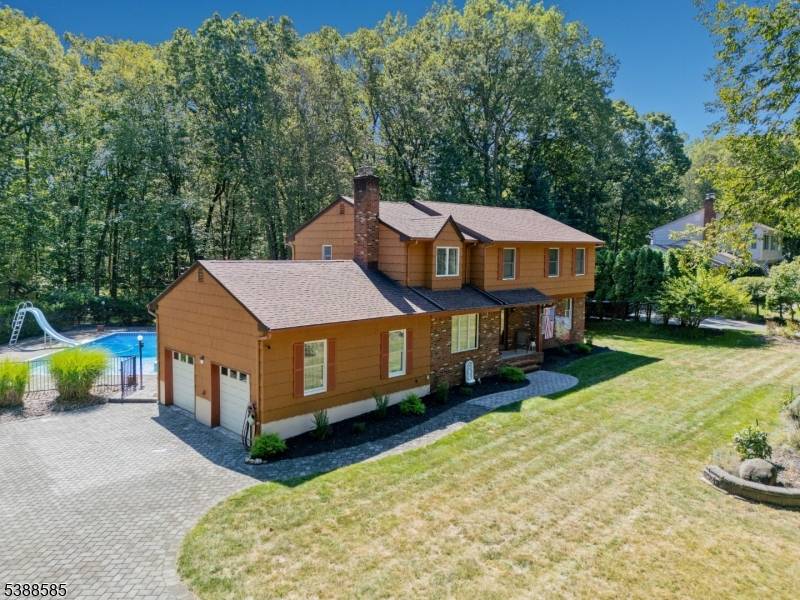 Located in West Hills Estates, on what many call one of the prettiest streets in Ramsey and sitting on approximately 1.