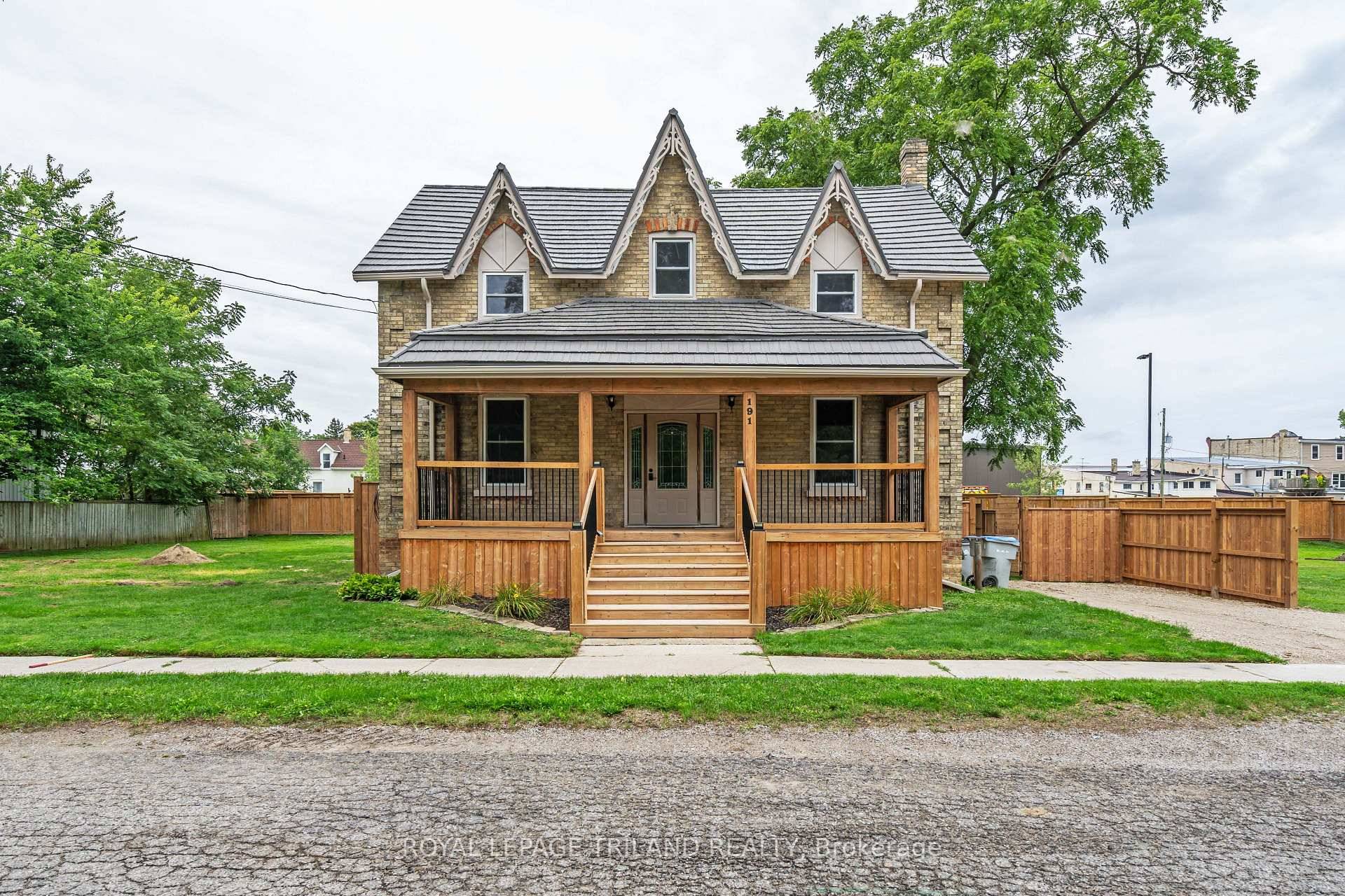 Welcome to this beautifully updated 2 story yellow brick home, brimming with curb appeal thanks to its inviting covered front porch and gardens.