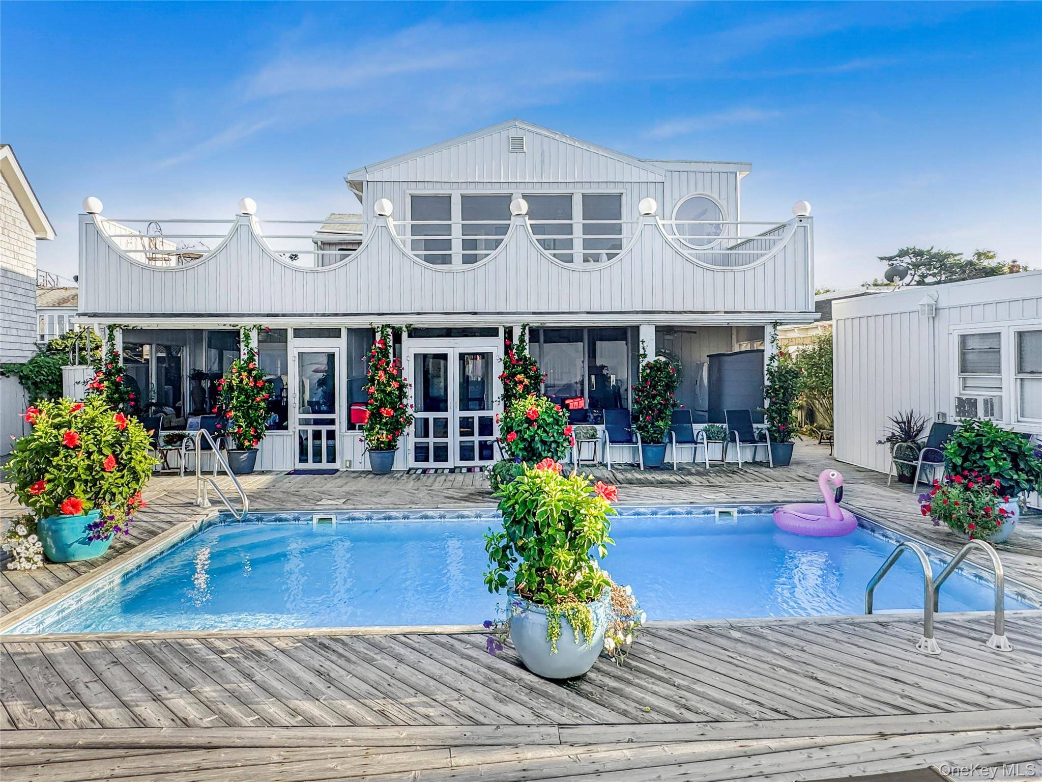 Rare 4 bedroom bayfront home offering multiple private living spaces and a solar electric heated pool, perfectly combining lifestyle and investment potential.