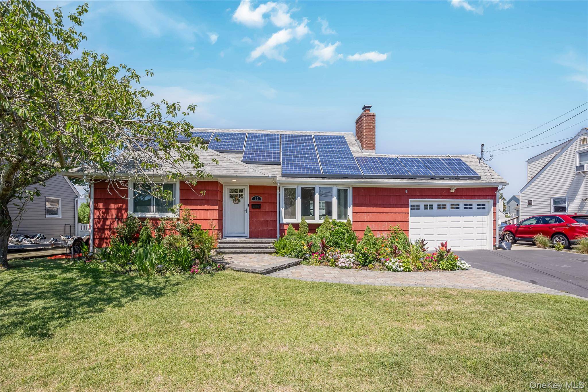 Nestled Along the Serene Waterfront, is this Charming Home with a Beautifully Manicured Front Yard.