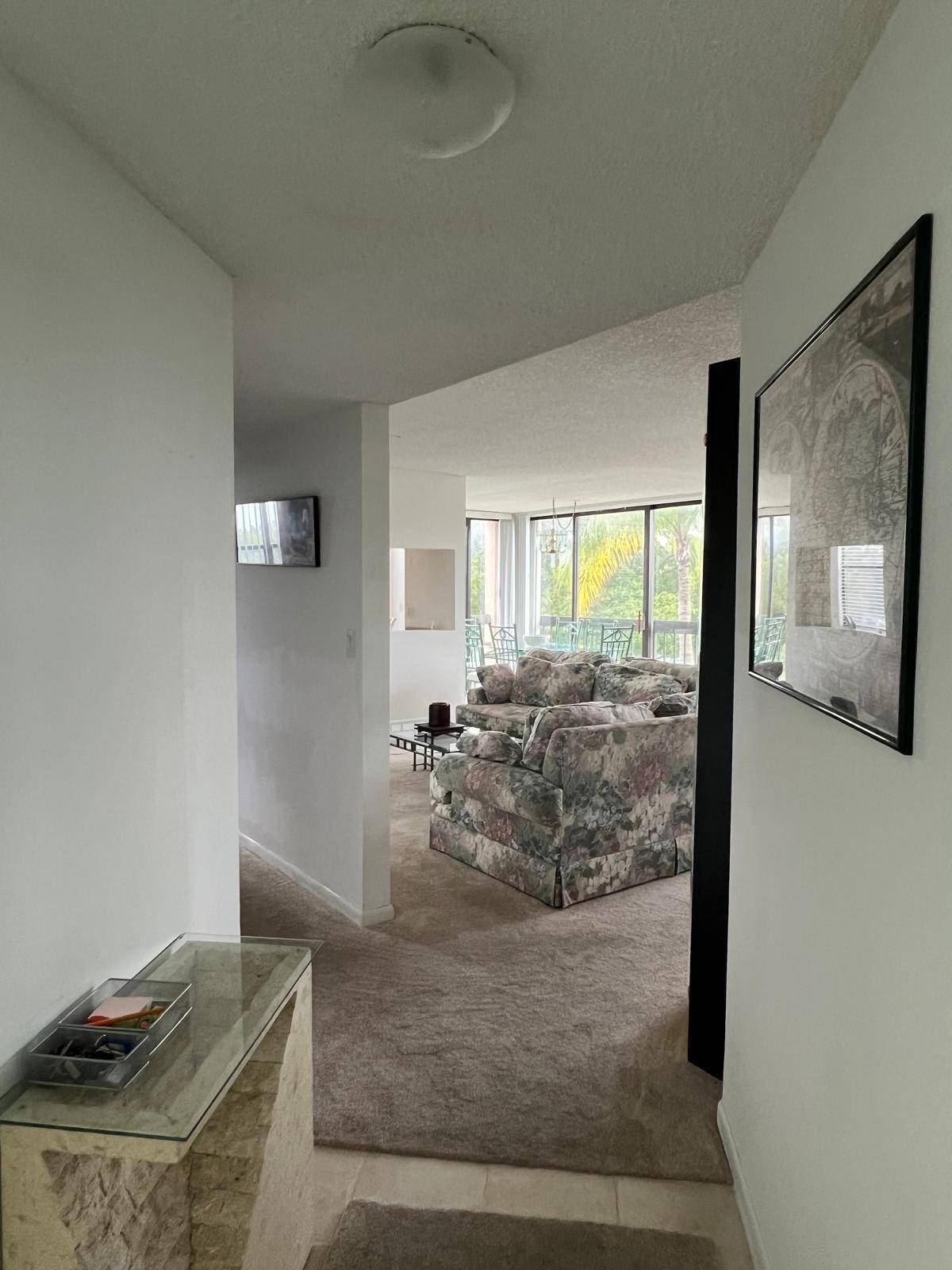 Rarely available CORNER unit with enclosed balcony that seamlessly extends the living area.