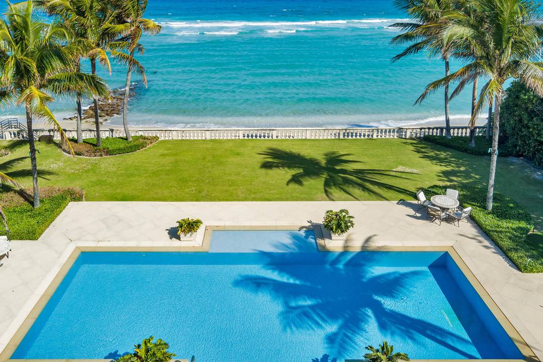 Magnificent direct oceanfront Palm Beach estate boasting 125 feet of pristine beach frontage.