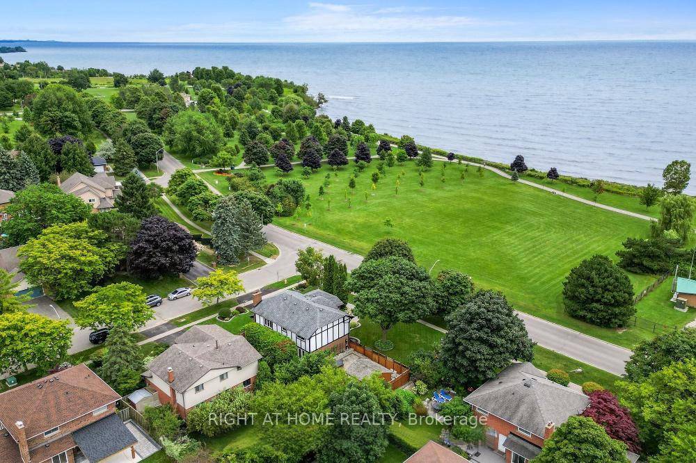 RARELY OFFERED Nestled on large corner lot on Lake Driveway W, this exceptional home offers lakefront living with Unobstructed views of Lake Ontario Updates include hardwood and porcelain tile floors, ...