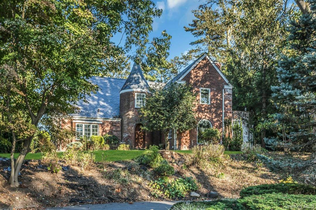 This impressive brick and stone Tudor blends timeless elegance with modern comfort in one of the most desirable settings, overlooking the Strathmore Vanderbilt Country Club.
