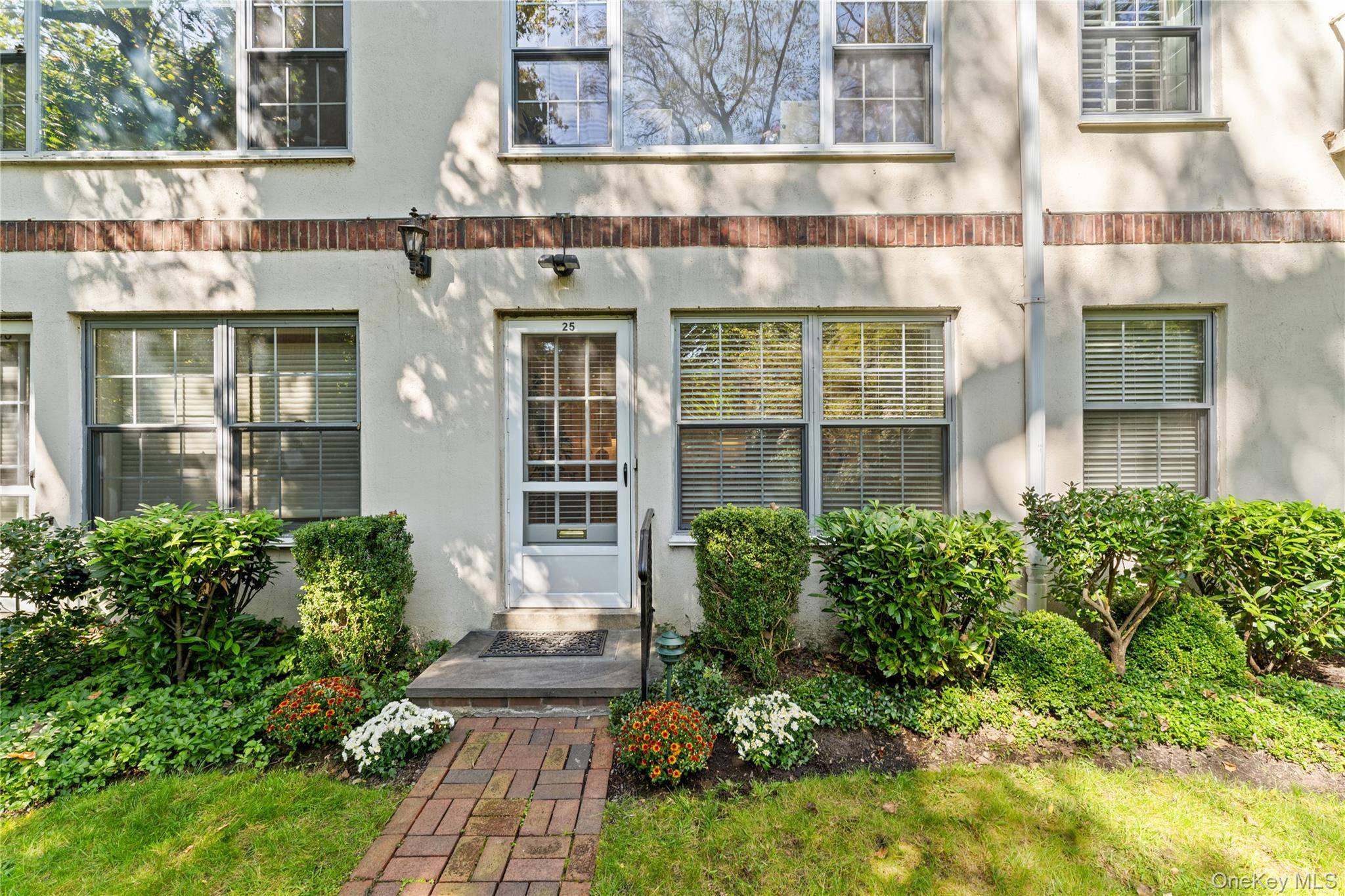 Step right out your front door into a peaceful setting with a lush lawn, garden, and plenty of privacy.