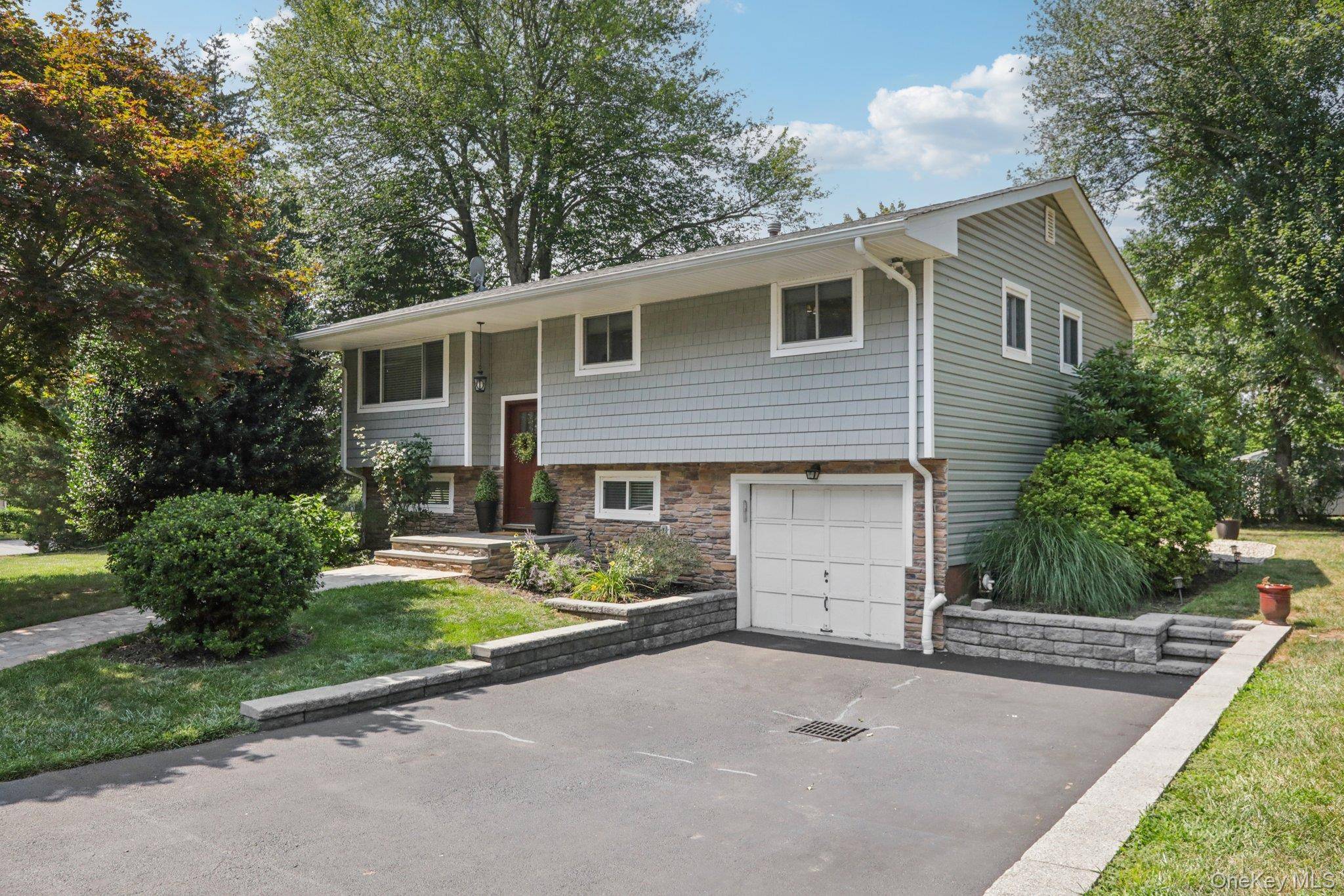 Beautiful and well maintained Hi Ranch home located on a quiet street in the heart of Valley Cottage.