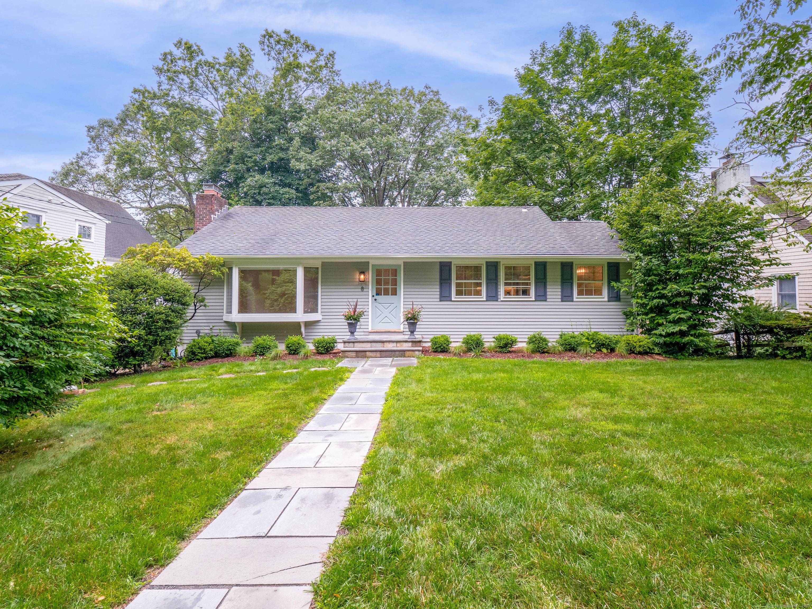 Year Round Rental in Noroton Heights This stylish three bedroom two bathroom home has a sun filled living room with fireplace and a large picture window.