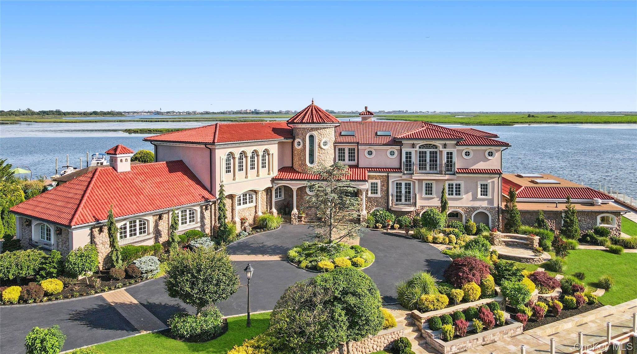 Discover an extraordinary opportunity to own a rare peninsula property in the prestigious enclave of Hewlett Harbor, where the water meets the sky in a breathtaking display.