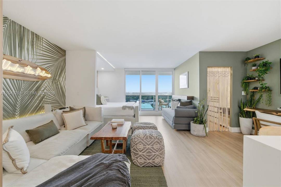 High floor, renovated studio, with a balcony, showcases unobstructed panoramic views of Miami, Biscayne Bay, and nightly sunset skies.