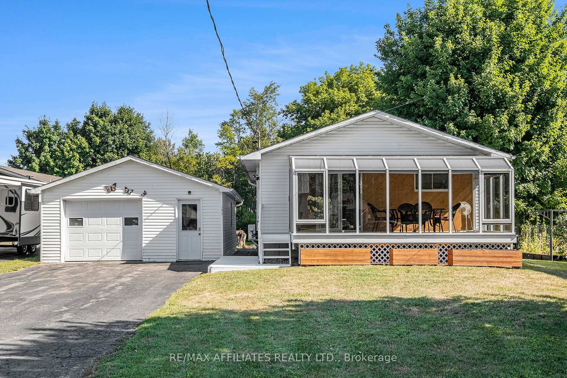 Welcome to this delightful bungalow that combines charm, functionality, and extra living space, all on a beautiful lot.