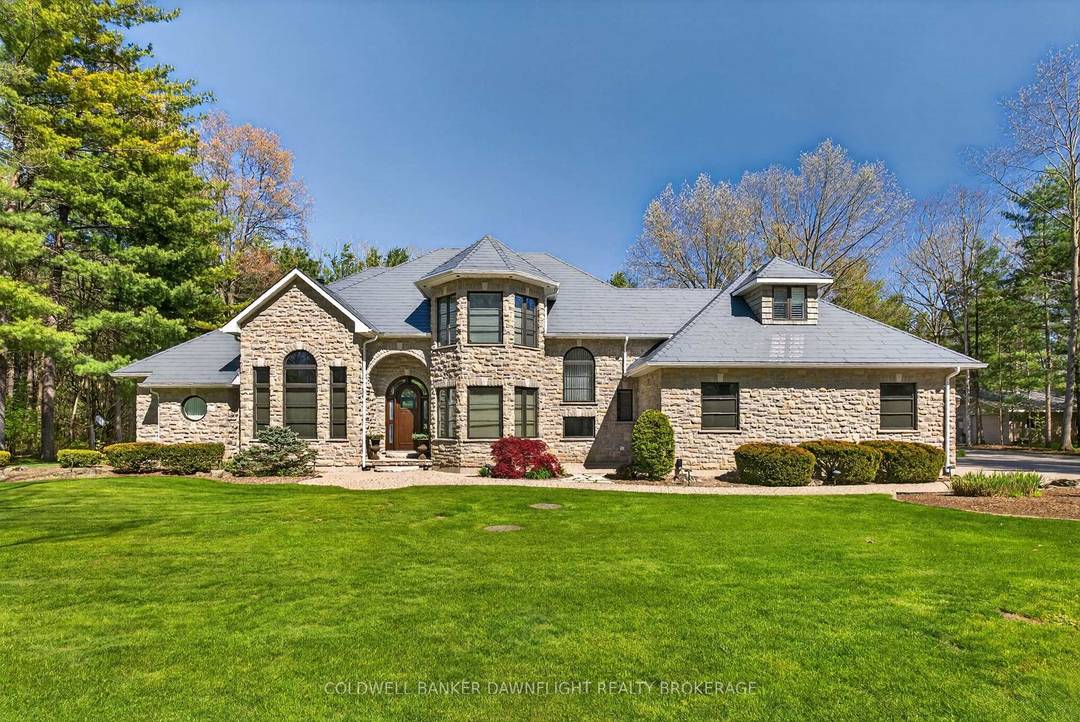 A custom built home showcasing exceptional craftsmanship, this one of a kind property features a striking Mennonite crafted stone exterior and durable metal roof.