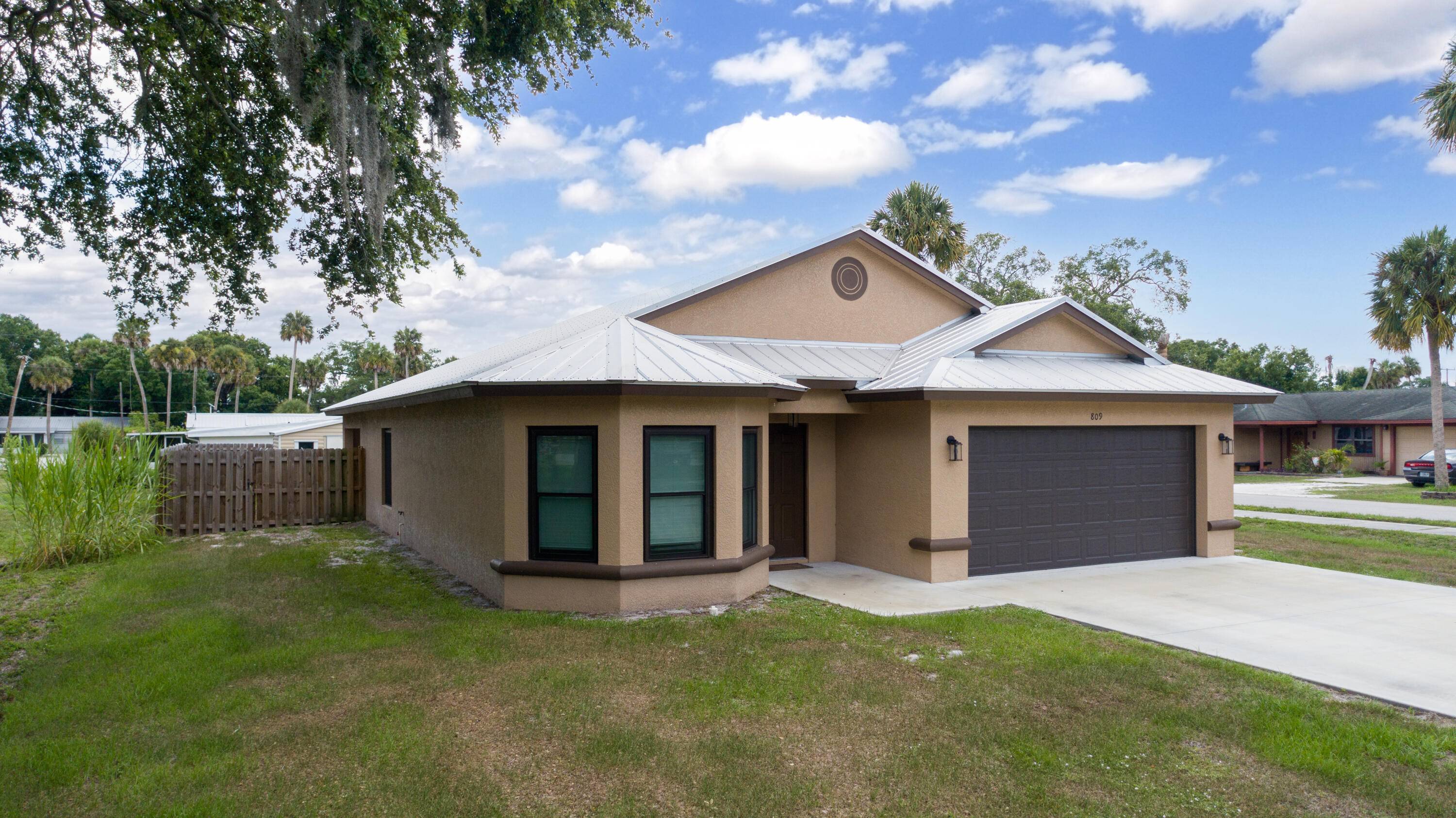 This 2021 custom built 3 bedroom, 2 bathroom, 2 car garage CBS home features impact windows, a durable metal roof, and energy efficient solar panels.