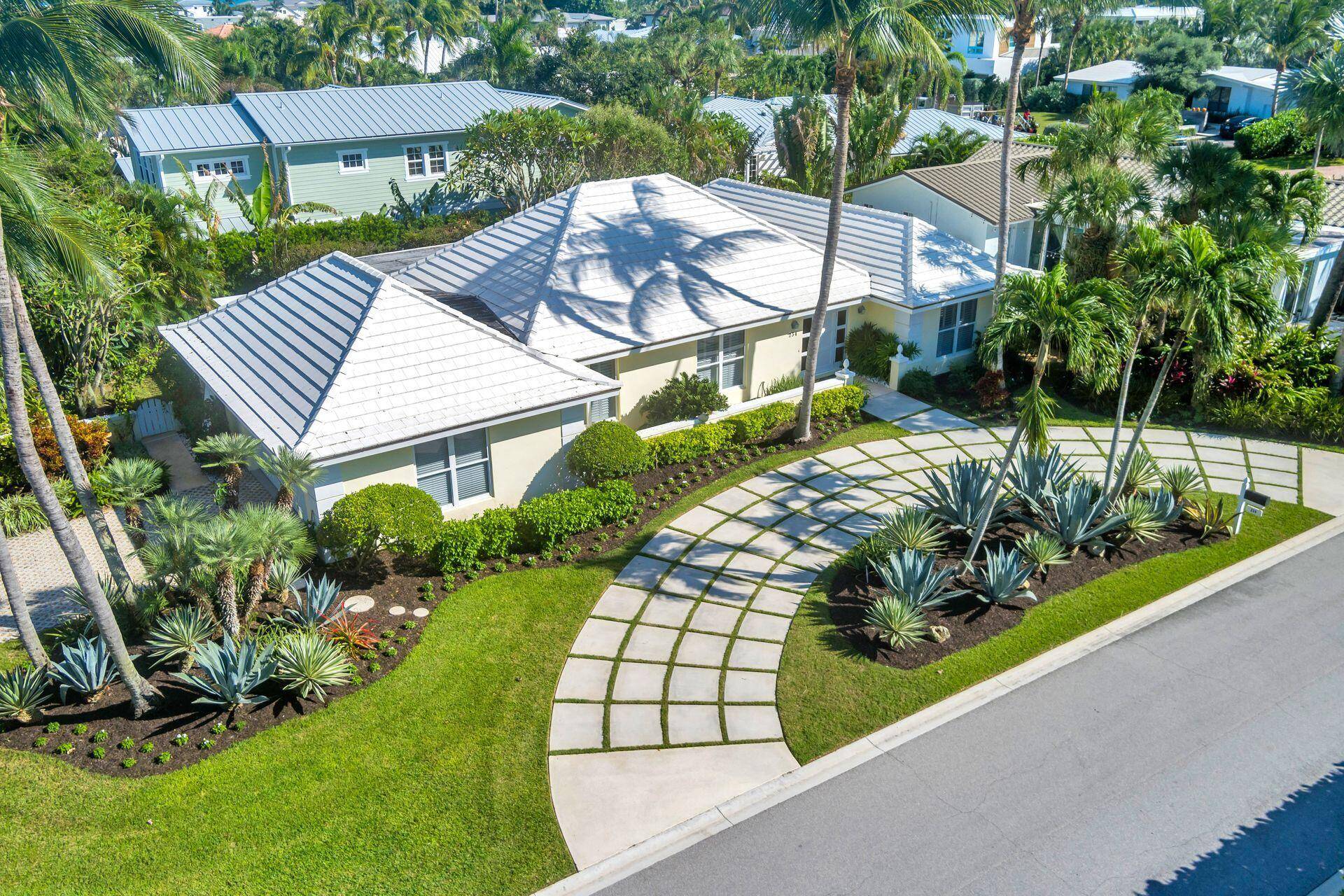 Welcome to this Classic Bermuda Style home in Jupiter Inlet Colony.