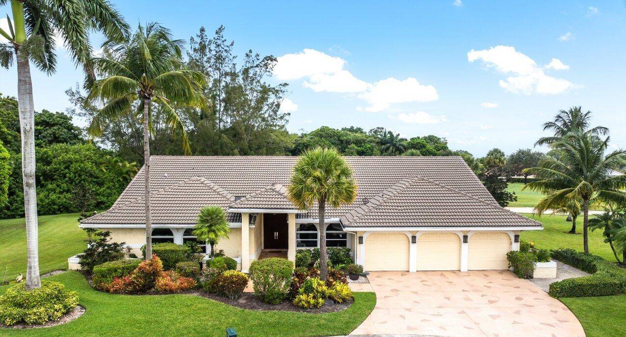 Elegant custom home on a rare oversized lot at the end of the cul de sac on one of the most desirable streets in prestigious Boca Woods Country Club, this ...