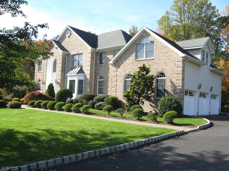 FABULOUS GRAND RENOVATED COLONIAL WITH WOOD FLOORS THRU OUT, CUSTOM MOLDING, TILEWORK, BOLD ARCHITECTURAL ACCENTS, DRAMATIC DETAILS, 9' TRAY CEILINGS, FLOOR TO CEILING STONE FIREPLACE IN FAMILY ROOM.