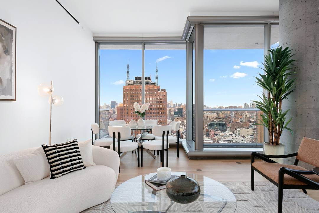 Step into a world of light, space, and luxury in this expansive three bedroom residence, perched high above Tribeca with panoramic skyline and river views.