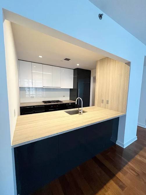 Luxurious amp ; spacious studio apartment with a home office or sleeping alcove.