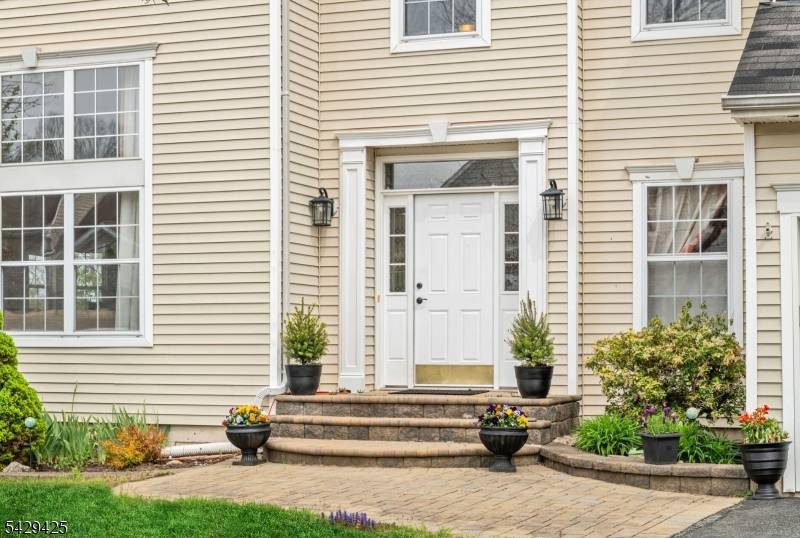 Welcome to this beautiful Colonial, perfectly situated on a quiet tucked away street with wooded privacy and magnificent tree top skyline views.